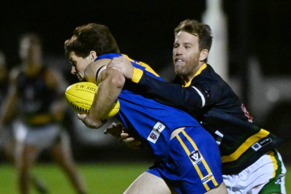 Tony Lockyer of Sebastopol is tackled by Michael Foster of Lake Wendouree. Picture by Kate Healy