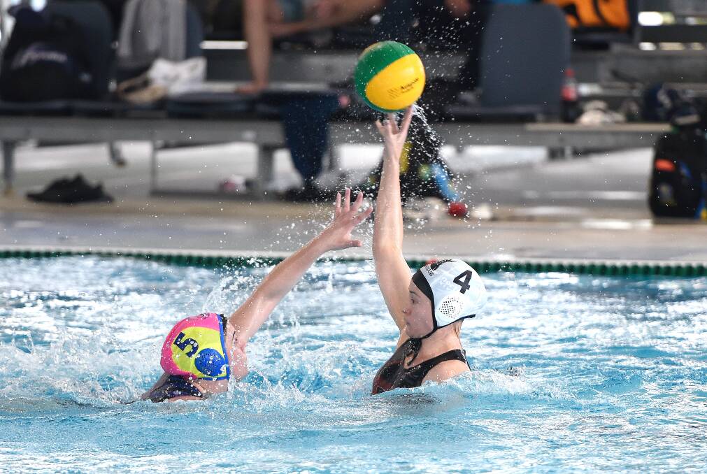 TOUGH BATTLE: Hannah Calverley of Ballarat and Melissa Di Donato of Geelong at the country waterpolo championships. Picture: Adam Trafford