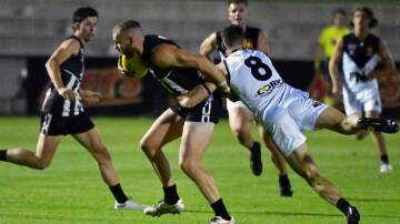 Darleu's Brett Bewley is tackled by Harry Loader of North Ballarat. Bewley would amass 51 touches on Saturday night. Picture by Kate Healy