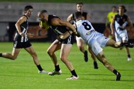 Darleu's Brett Bewley is tackled by Harry Loader of North Ballarat. Bewley would amass 51 touches on Saturday night. Picture by Kate Healy
