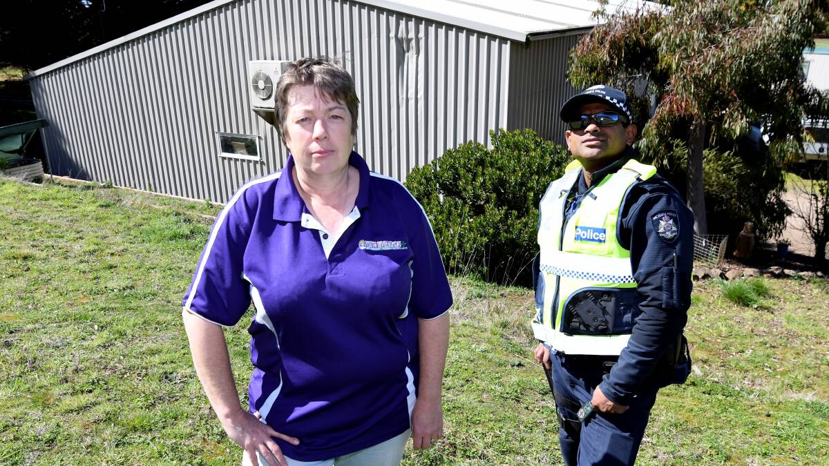 Coral Loader and Senior constable Sean Almeida show off the scars where the tyres hit the shed. Picture: Lachlan Bence