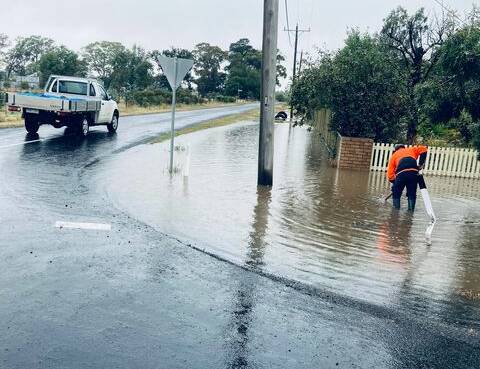 A worker attends to flood waters in Clunes on Friday. Picture: Joseph Perse