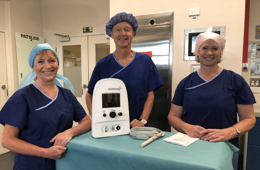 Surgeon Ruth Bollard with Andrew Byrne and Sandra Page from BJT Legal with the new device. Picture: Greg Gliddon