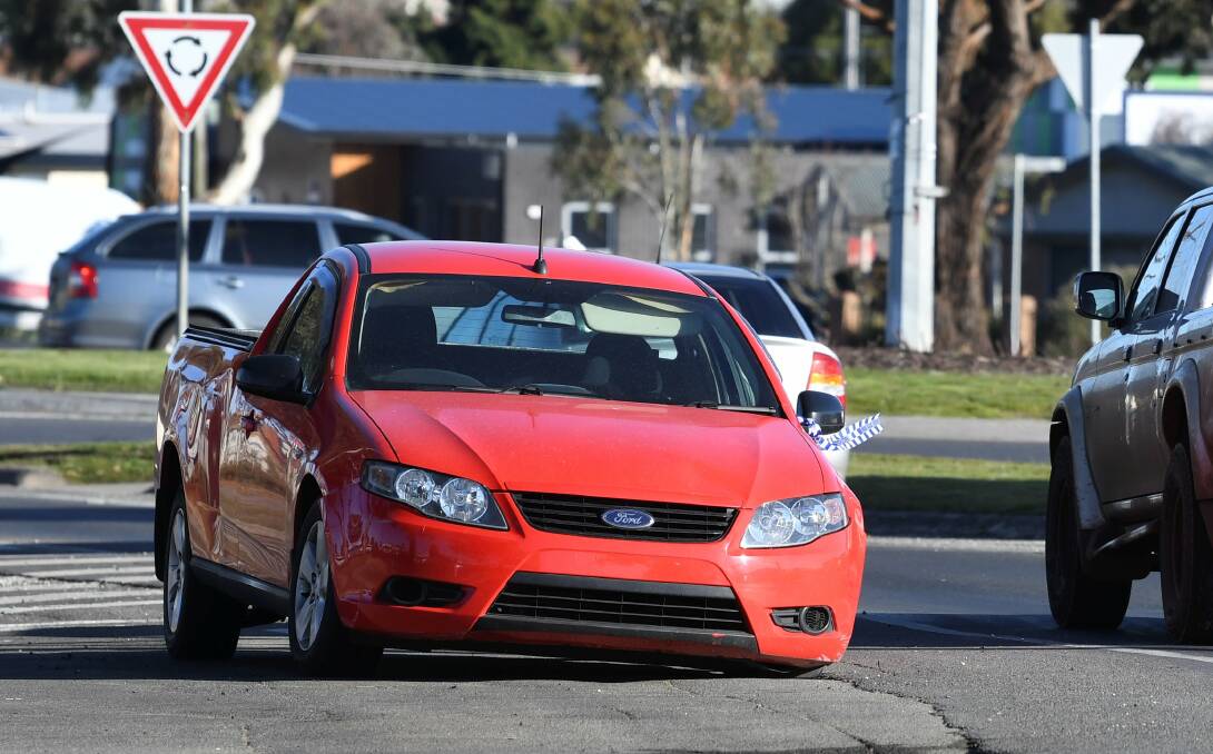 ABANDONED: A red Ford ute parked near the corner of Gillies and Norman streets in Wendouree for days has finally been removed by VicRoads. Picture: Lachlan Bence