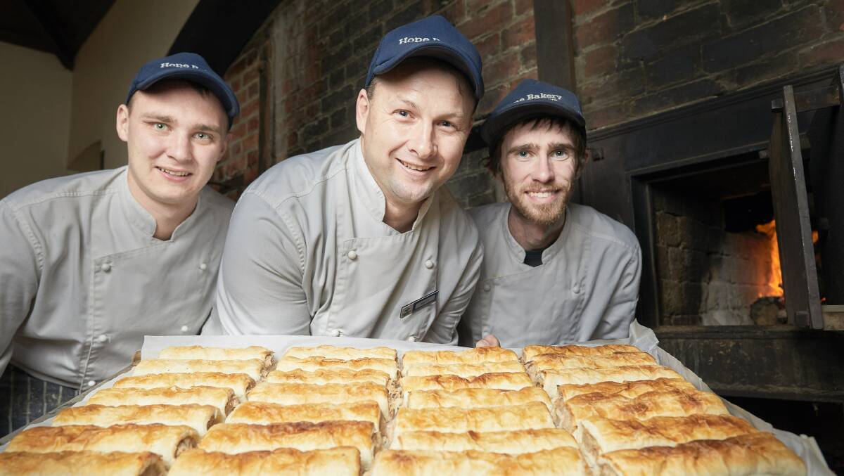 Rohan Giblett (Baker), Matt Beaston (Head Baker) and Steven Smartt (Baker) with the award winning sausage rolls. Picture: Luka Kauzlaric