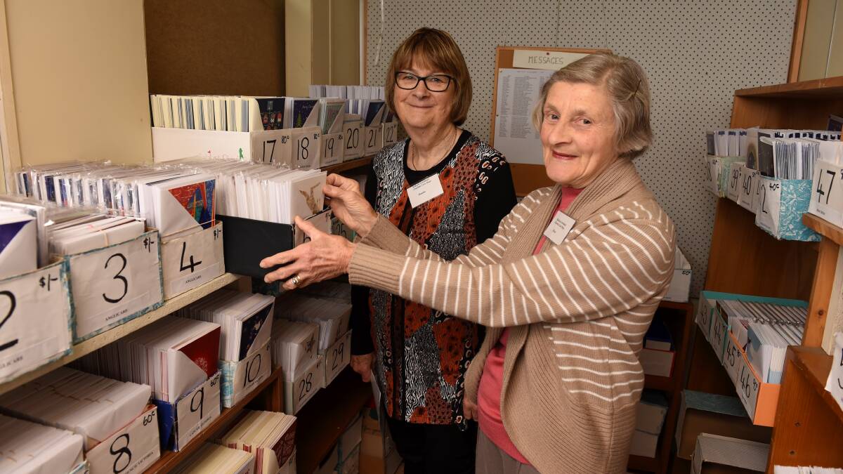 CHRISTMAS SPIRIT: Denise Boyko (left) and Rose O'Meara (right) at the Combined Charities Christmas Card Shop on Eyre Street in Ballarat. Picture: Lachlan Bence 