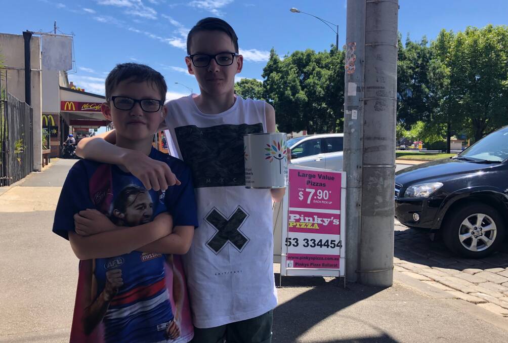 LOW ACT: Levi, 9 and Jayden, 14, have been raising money for the Royal Children's Hospital with the help of Pinky's Pizza, but their hard work has been undone by a callous thief. Picture: Greg Gliddon