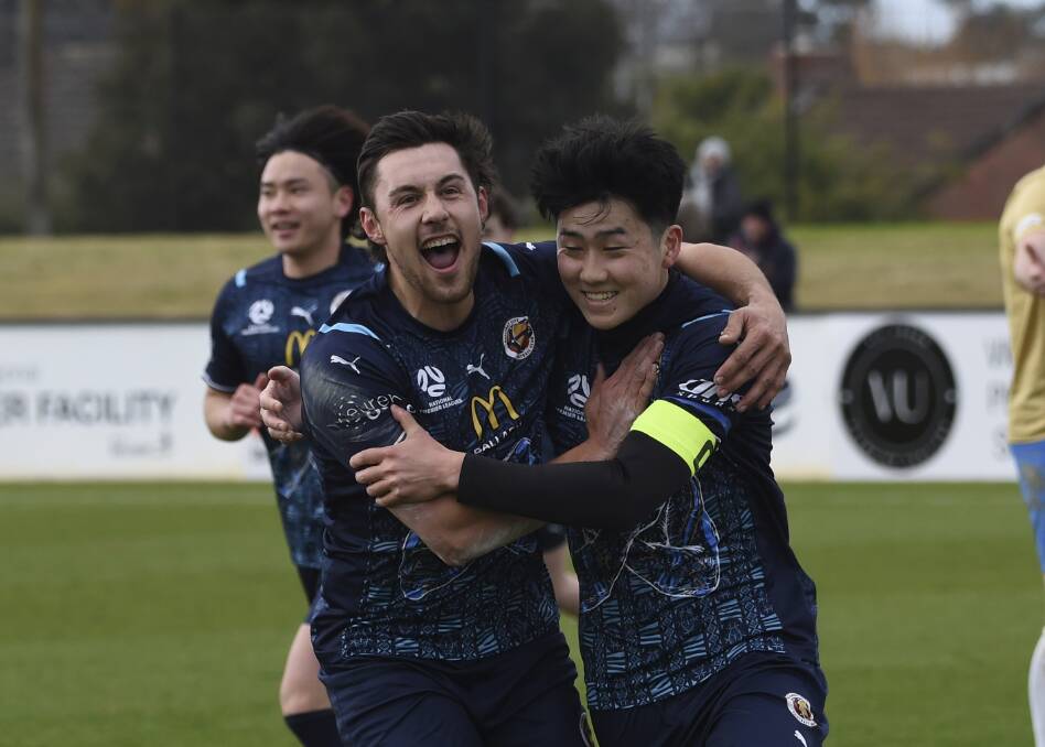 Daniel Angelski and Yushiro Shiomi of Ballarat City celebrate one of the club's four goals on Sunday. Picture by Lachlan Bence