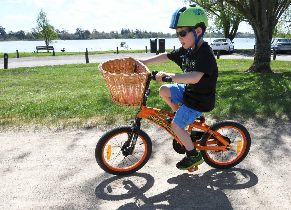 Five year old Jack made the most of the spring sunshine on Tuesday with a ride around Lake Wendouree. Picture: Lachlan Bence