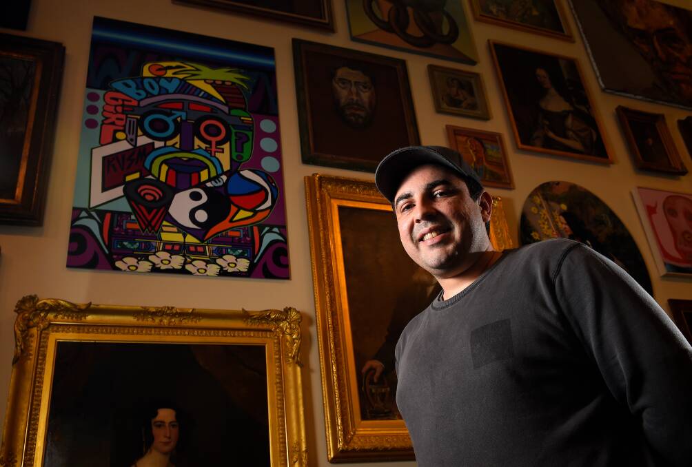 Ballarat artist Joshua Muir at the Ballarat Art Gallery by his painting which hangs on the main staircase. Picture: Adam Trafford