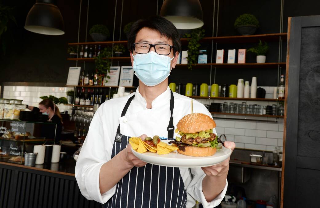Owner/Chef Frank Dong with the Down to Earth, a Mexican style vegan burger. The The Tin Roof Cafe is participating in the Plate Up Ballarat vegetarian challenge from Thursday to Sunday. Picture: Kate Healy