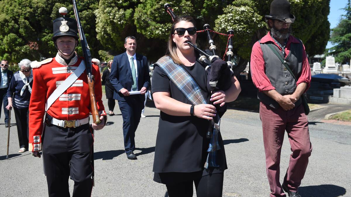Bagpiper Amber Ives leads the Eureka Day procession at the Ballarat Old Cemetery. Picture: Kate Healy 
