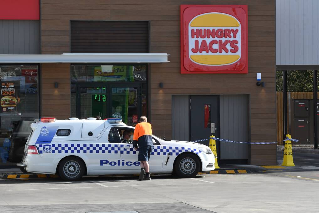 Police outside the Hungry Jacks at Redan after last night's robbery. Picture: Lachlan Bence