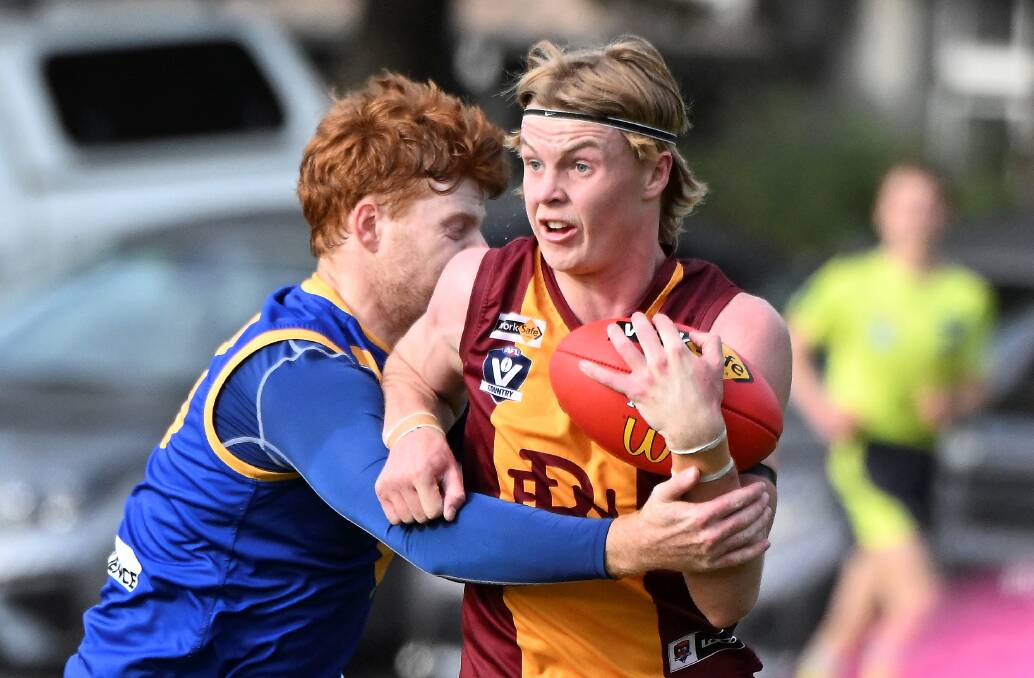 Rory Gunsser of Redan under pressure in the clash against Sebastopol. Picture by Lachlan Bence