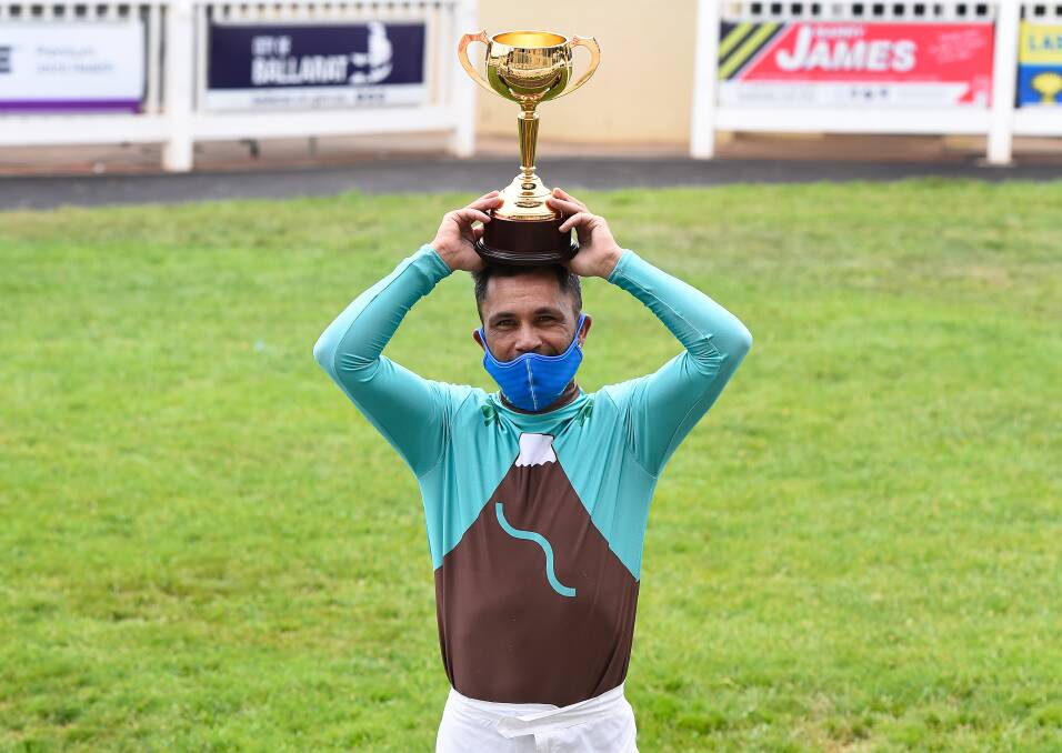 Jockey Michael Walker was left holding the Ballarat Cup on his own after a very-different, and socially distant running of the race on Saturday afternoon. Picture: Adam Trafford