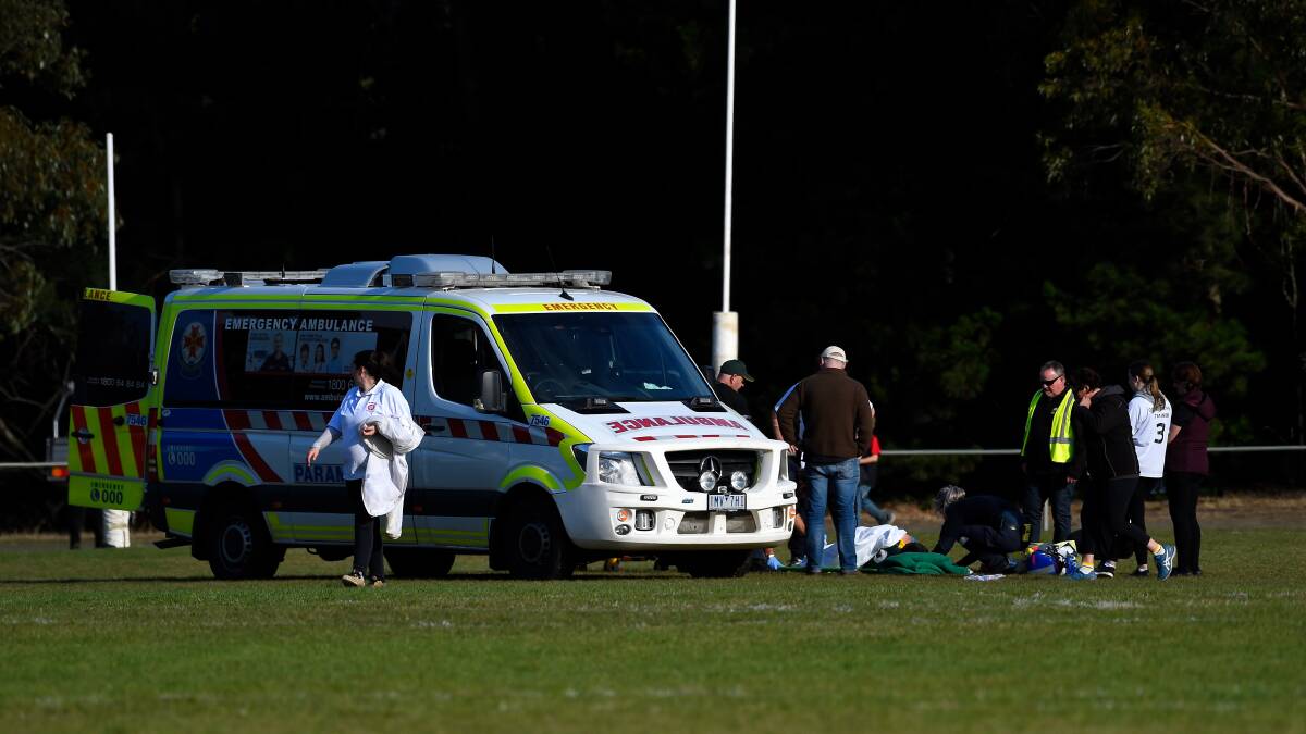 An ambulance tends to an injured footballer at Gordon on Saturday. Picture: Tim O'Connor