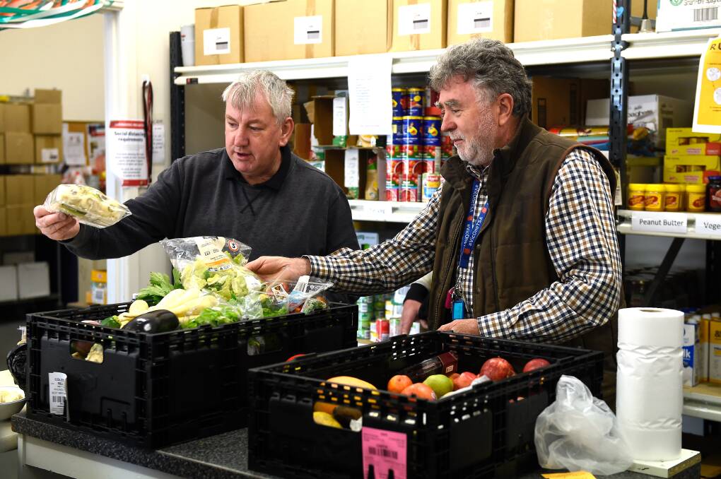Rob - Volunteer (left) with John Clonan - Doorways Team Leader sort food received from local supermarkets in the grocery box program room. Picture: Adam Trafford