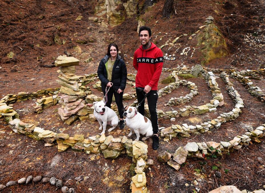 ART IN FOCUS: Chloe Hughes and Johnny Roberson have been adding to the art installation in the Black Hill Reserve. Picture: Adam Trafford