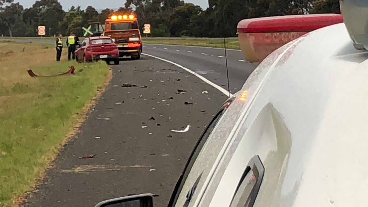 Damage was strewn across the emergency lane on the east bound lanes of the Western Highway this morning after a crash between a car and a light truck. Picture: Greg Gliddon