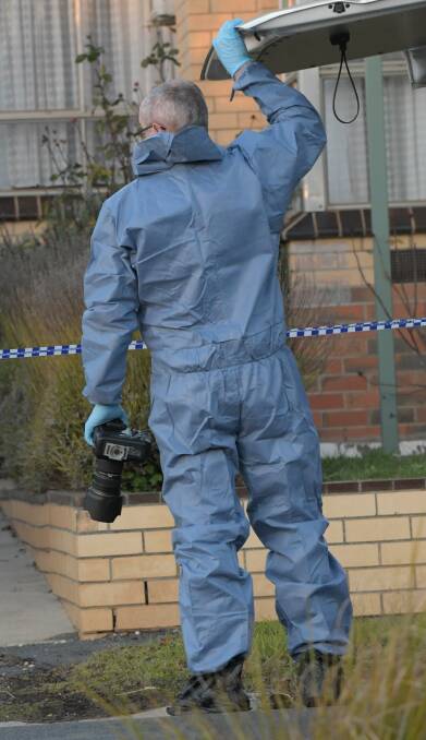 INVESTIGATING: A police officer near the crime scene on July 15, 2018. Picture: NONI HYETT