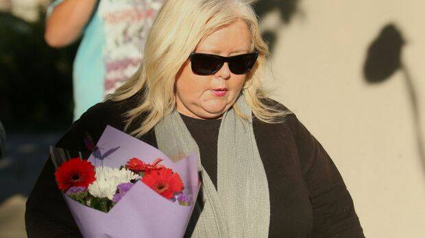 A woman delivers flowers to the Ristevskis' home on Tuesday. Picture: PAT SCALA
