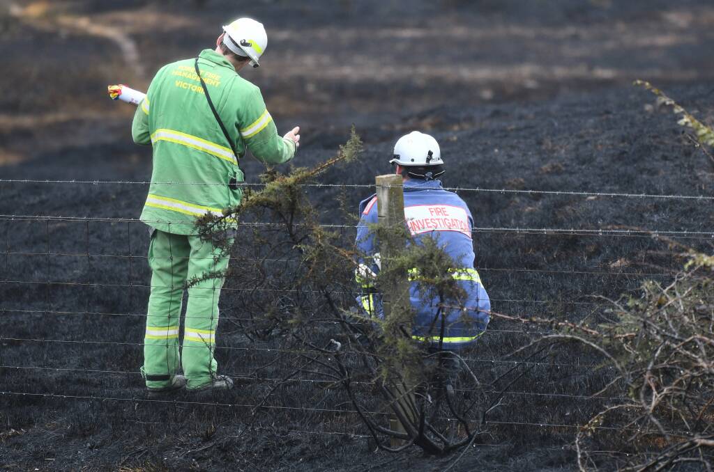 Fire investigators at the scene the morning after the Allendale fire. Photo: Lachlan Bence