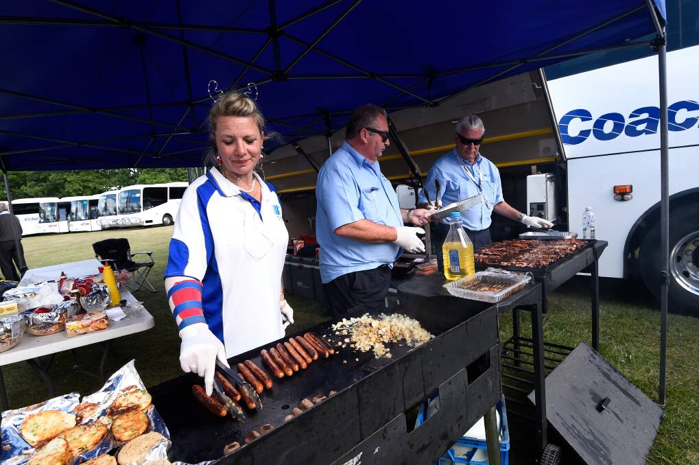 Tabitha Browne, Leo Krause and Iain Beveridge cooking a BBQ for the bus drivers. Photo: Adam Trafford