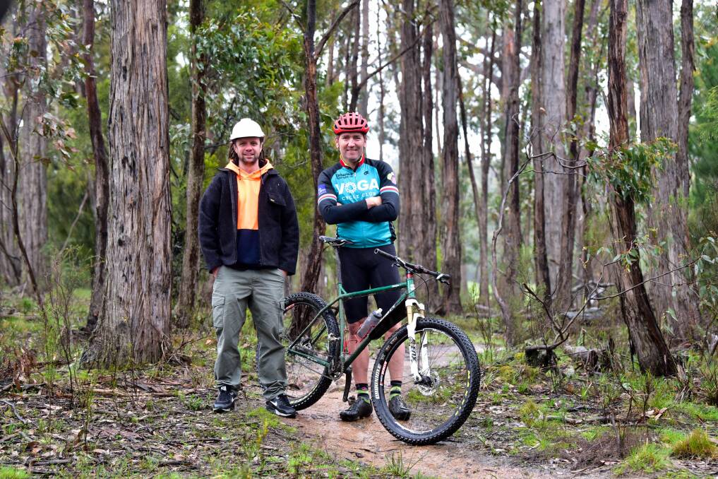 Mick McCallum (Hepburn Shire Council Construction Manager for Creswick Trails Project) and local trail enthusiast Mick Veal in bushland near Creswick. Photo: Brendan McCarthy