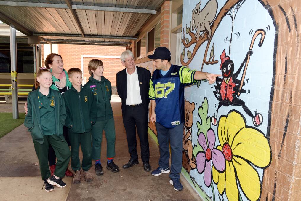 LEARNING: Grade 6 pupil Jalissa, principal Mel Stewart, grade 5 pupil Brody and grade 6 pupil Oscar with Hepburn Shire Council Mayor Don Henderson and Xavier Diaz with one of the school's art murals. Photo: Kate Healy