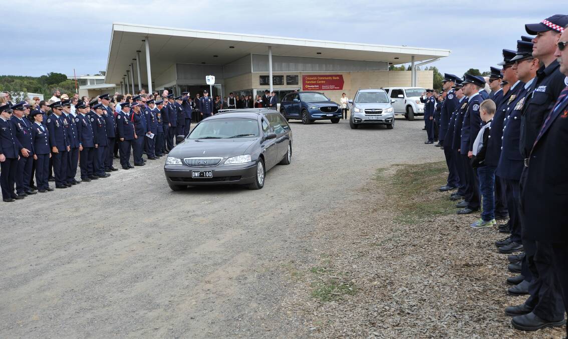 COMMUNITY HONOURS: Hundreds of people from the community and from further afield joined Country Fire Authority members to pay their respects by forming a lengthy guard of honour from the service to the gates of the venue. Photos: Lachlan Bence