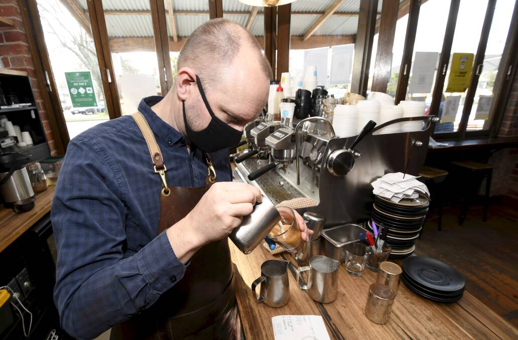 COFFEE FOR A CAUSE: Kris Jordan making coffees at Webster's Market and Cafe. Photo: Lachlan Bence