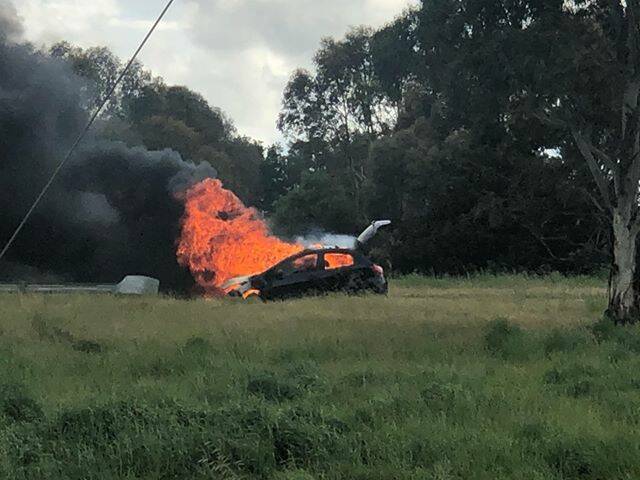 The car burst into flames about 4.40pm. Photo: Mitch Smith