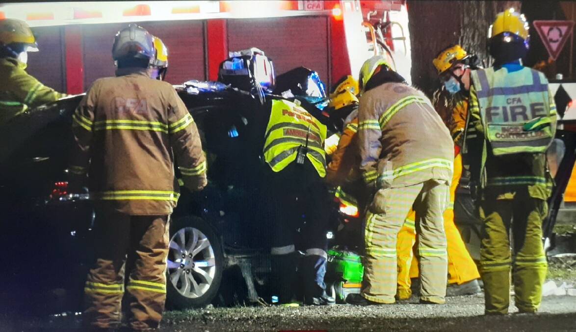Firefighters and paramedics work to free the man from his car. Photo: 4kTV