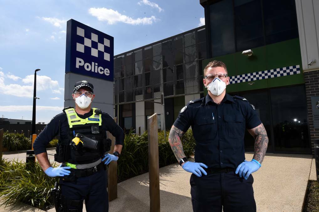 PRECAUTION: Sergeant Kori Fraser and First Constable Josh Courtney wearing personal protection equipment. Photo: Adam Trafford