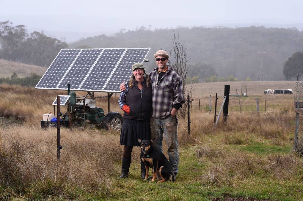 SUSTAINABLE EFFORT: Tammi and Stuart Jonas and dog Sol, pictured with a solar pump. Photo: Adam Trafford