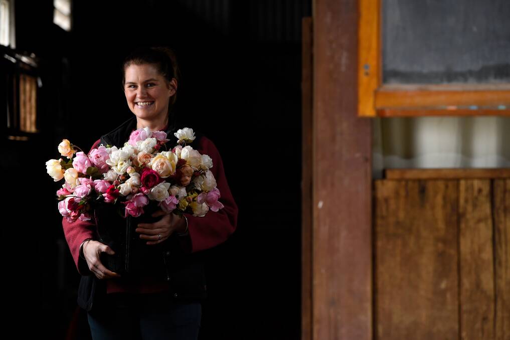 COLOUR: Kristy Tippett with a fresh bunch of blooms in her sorting shed at Soho Rose Farm. Photo: Adam Trafford