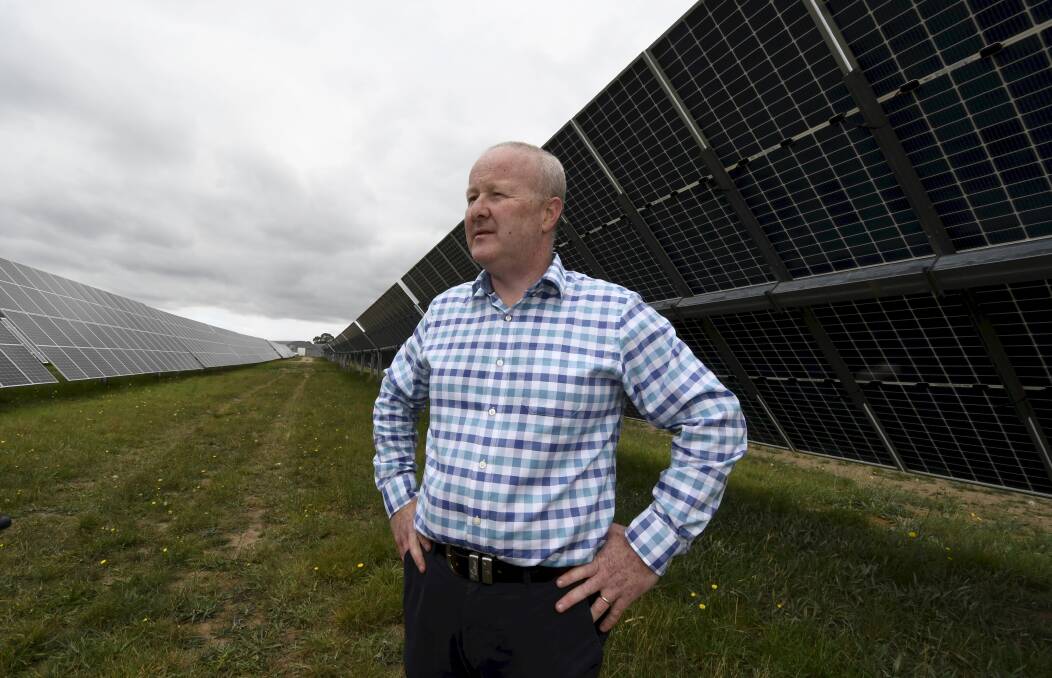 BIG PROJECT: Scott White among the solar panels. Photos: Lachlan Bence