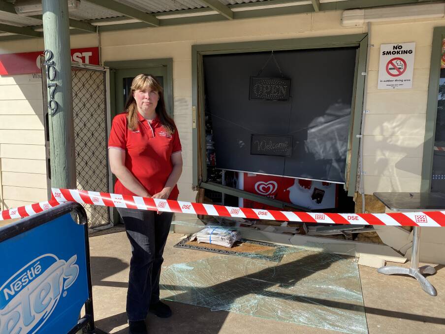 Karen Hinchliffe in front of the damage caused at the front of her shop.
