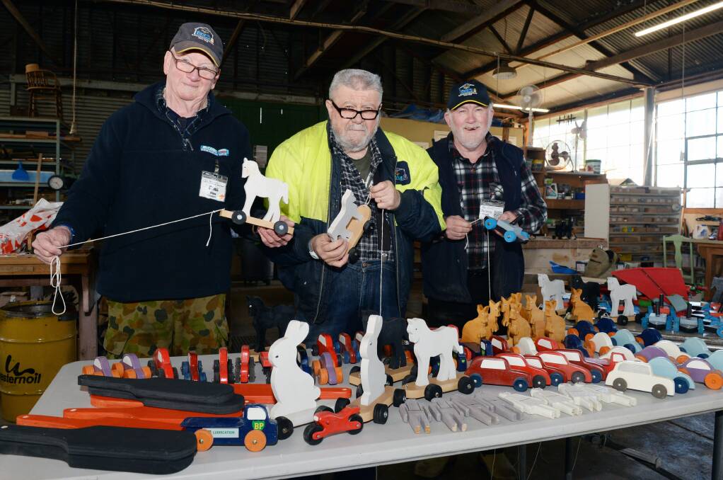 MADE WITH LOVE: Paul Times, Alan Buchanan and Rodney Sheean (Members of the Ballarat East Community Men's Shed) with some of their homemade toys. Photo: Kate Healy