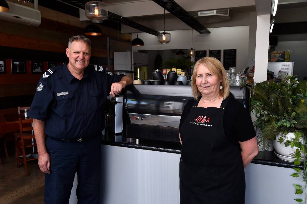 INITIATIVE: Leading Senior Constable Jim Ross with the owner of Lola's Cafe, Jenny Colley. Photo: Adam Trafford