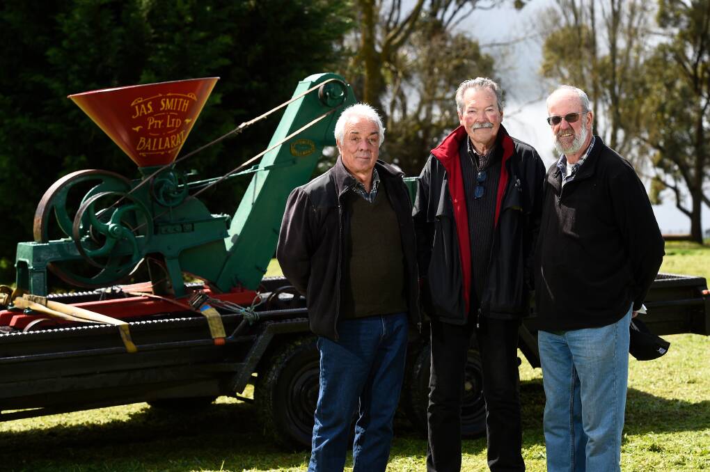 BIG EVENT: Rob Turley and David McCann of the Dean Recreation Reserve committee with Peter Bandy, President of the Ballarat Engine and Machinery Preservation Society in front of a Jas Smith Grain Crusher which will be on display at the upcoming Dean Sheepdog Trials this weekend. Photo: Adam Trafford