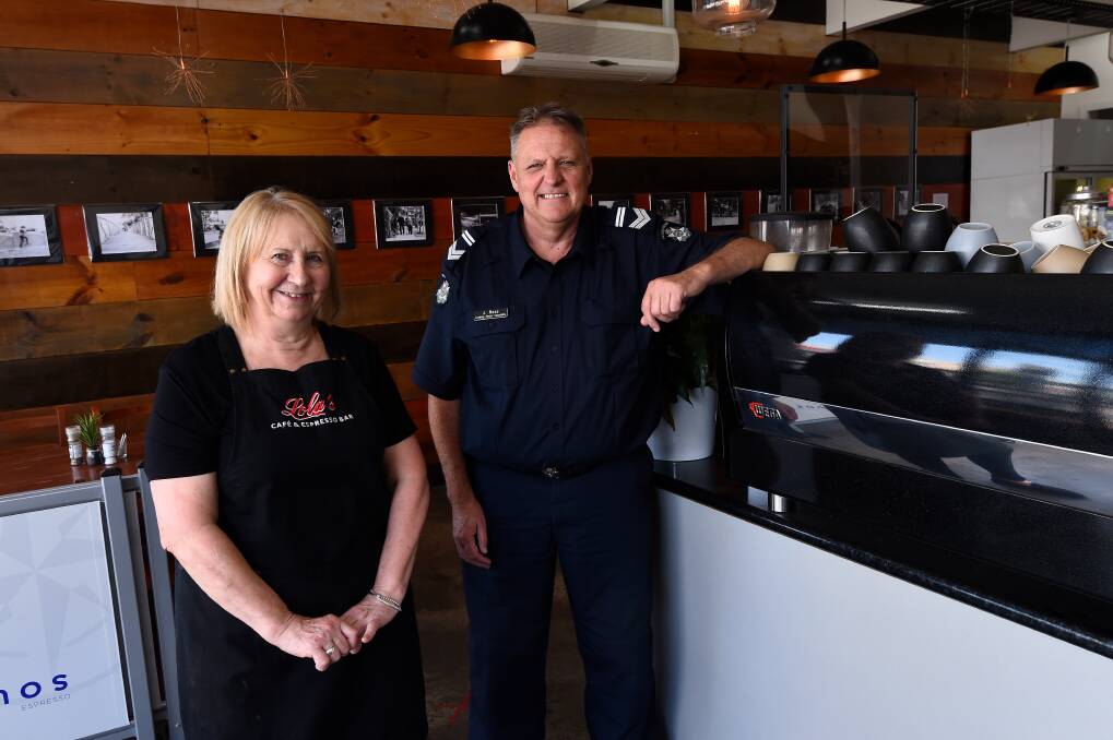 Jenny Colley, Owner of Lola's Cafe, with Leading Senior Constable Jim Ross. Photo: Adam Trafford
