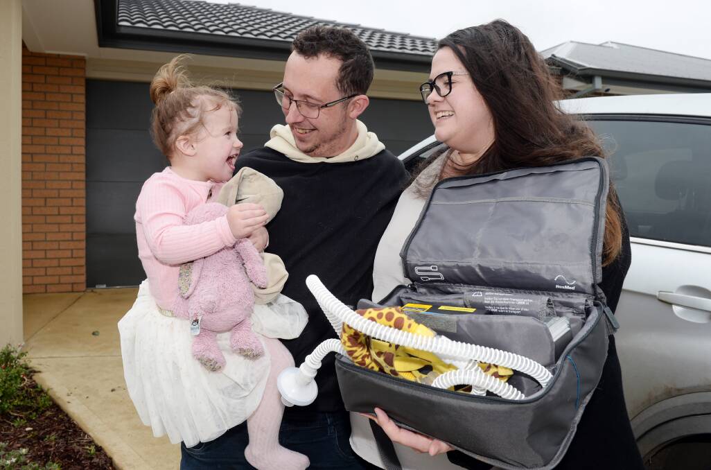 Sophie, aged two, with parents Ben and Amanda Stewart were relieved to find their stolen medical equipment had been returned on Monday morning. Photo: Kate Healy