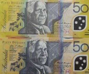 An image of a counterfeit $50 note (bottom) alongside a legitimate one.