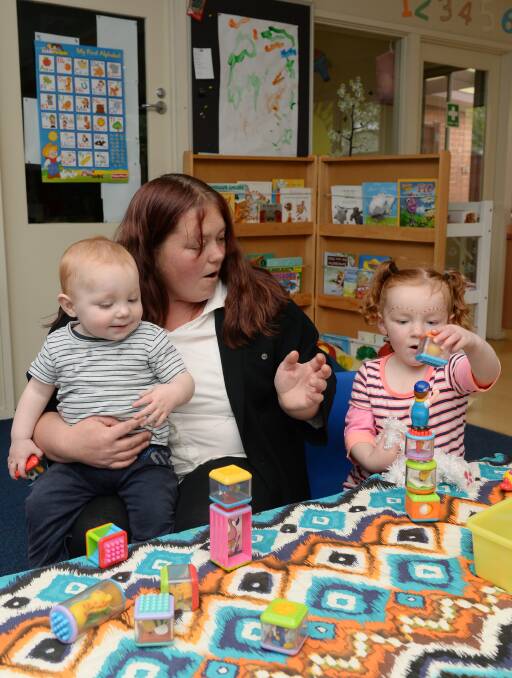 Safe: Chloe Jeffrey with her son Braxton Dowdy, 1, and Crystal-Rose Dowdy, 3, at SalvoConnect Western's childcare centre. Picture: Kate Healy.