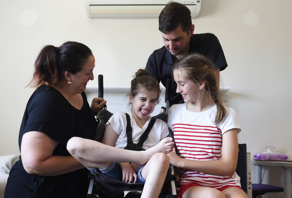 New Buggy: Jade Smith, 10, pictured with her mother Melissa, father Matthew and sister Abby, 11, needs new wheels to get around. Picture: Jessica Black.