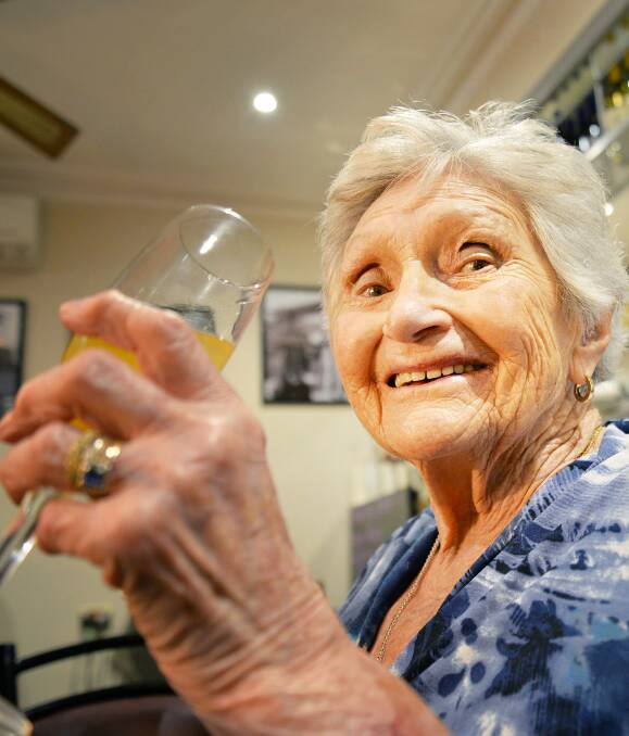 Cheers: Marjorie Hill is the first of her family to reach 100. The family has a history of "long genes" and Mrs Hill's aunt lived to 99. Picture: Jessica Black.