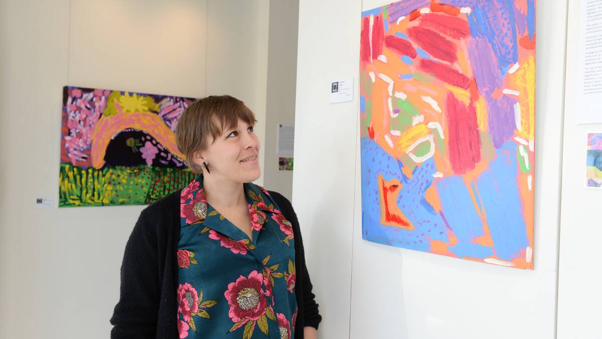 Artworks: Funky Turtle Artists' program co-ordinator Paige Duggard with an untitled work by artist April Brooks. Picture: Kate Healy.