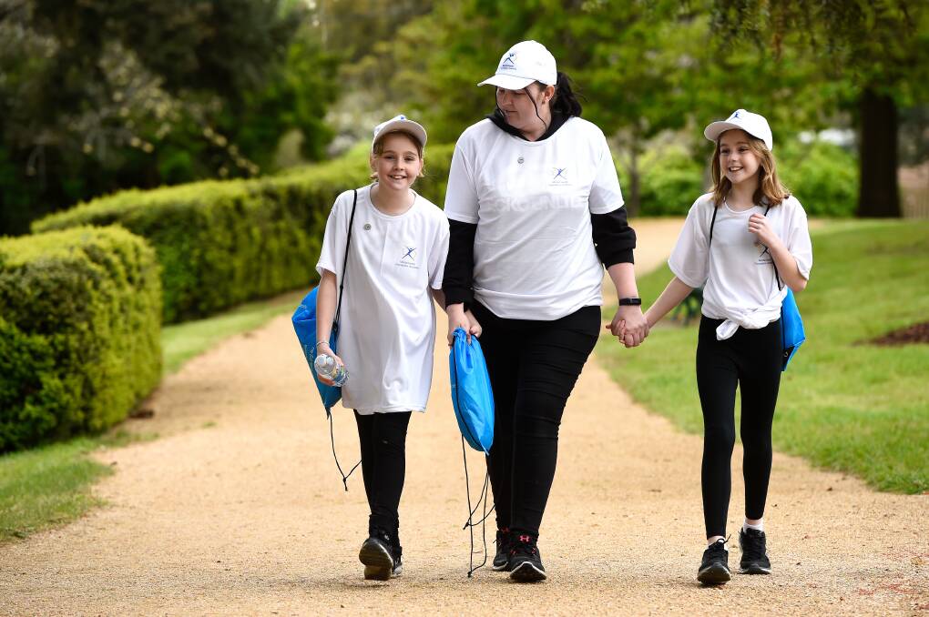 Kristy Cameron with her twin daughters Stephanie and Miley Cameron at the Walk for Mental Health in Buninyong Botanical Gardens. Picture: Adam Trafford.