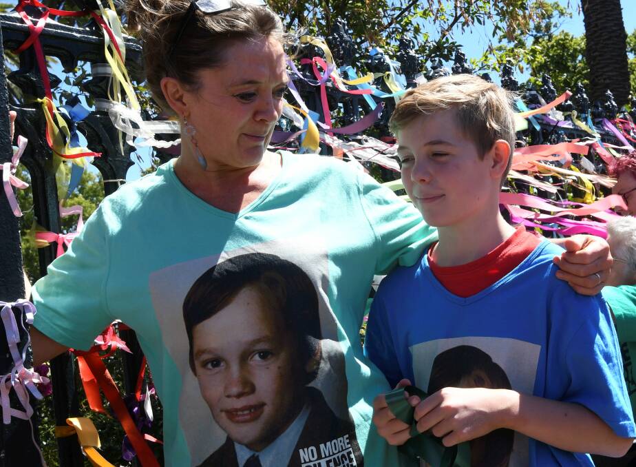 Peter's wife Clare Linane and their son Max stand by the Loud Fence outside St Patrick's Cathedral
